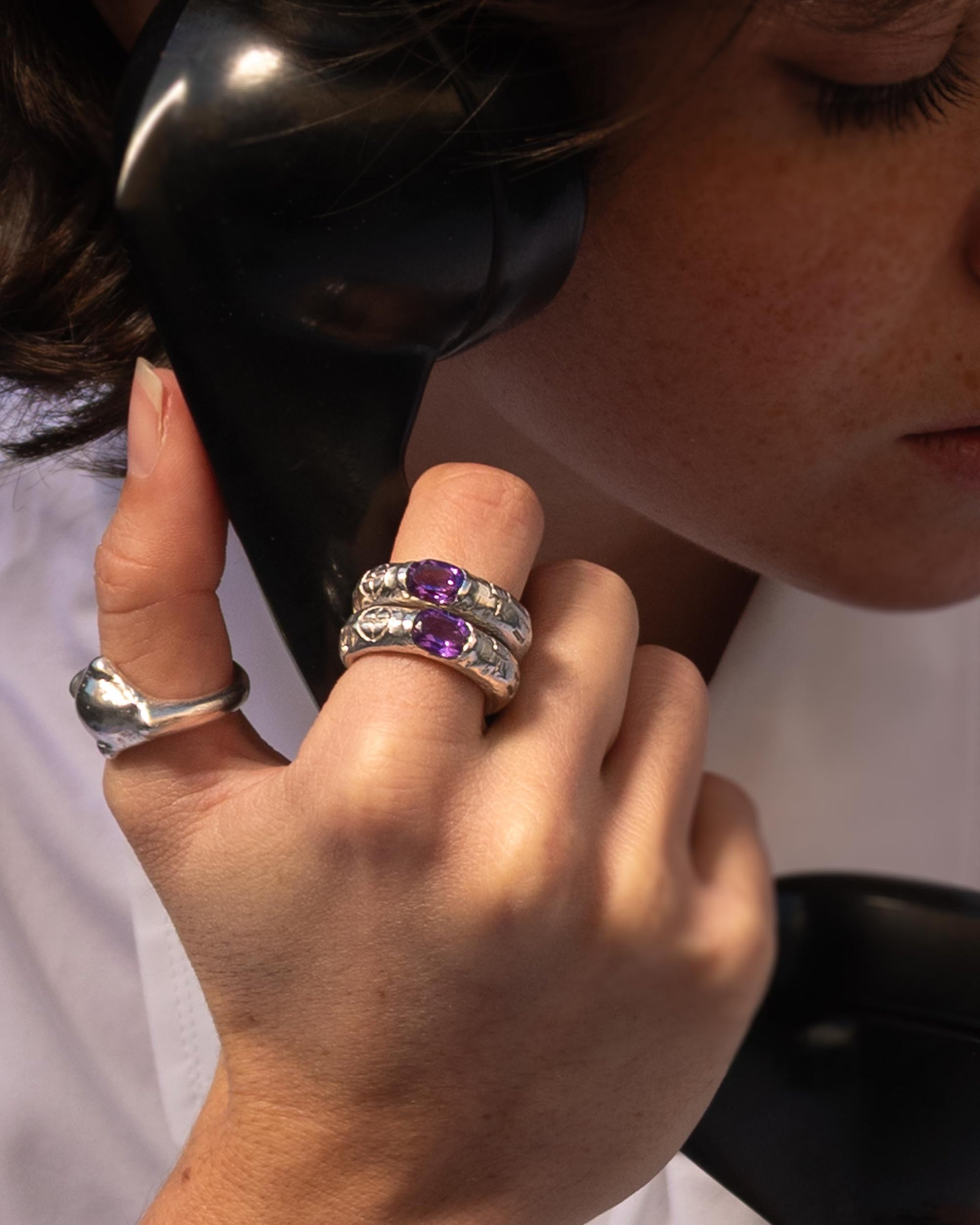 Silver ring with an african amethyst stone in the center.
