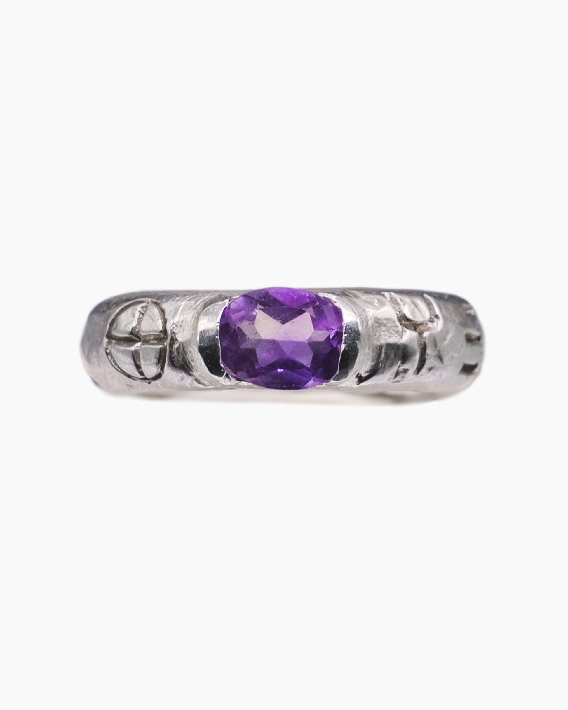 Silver ring with an african amethyst stone in the center and engravings front view