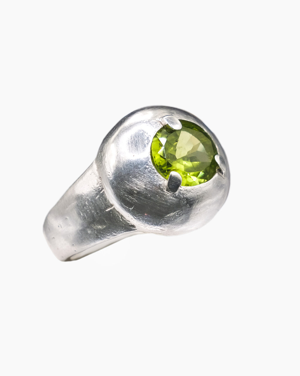 Silver shield shaped ring with a peridot stone in the center.