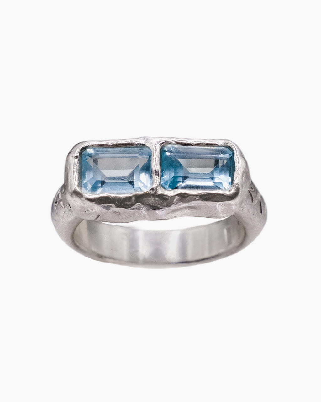 Silver ring with sky blue topaz stones.
