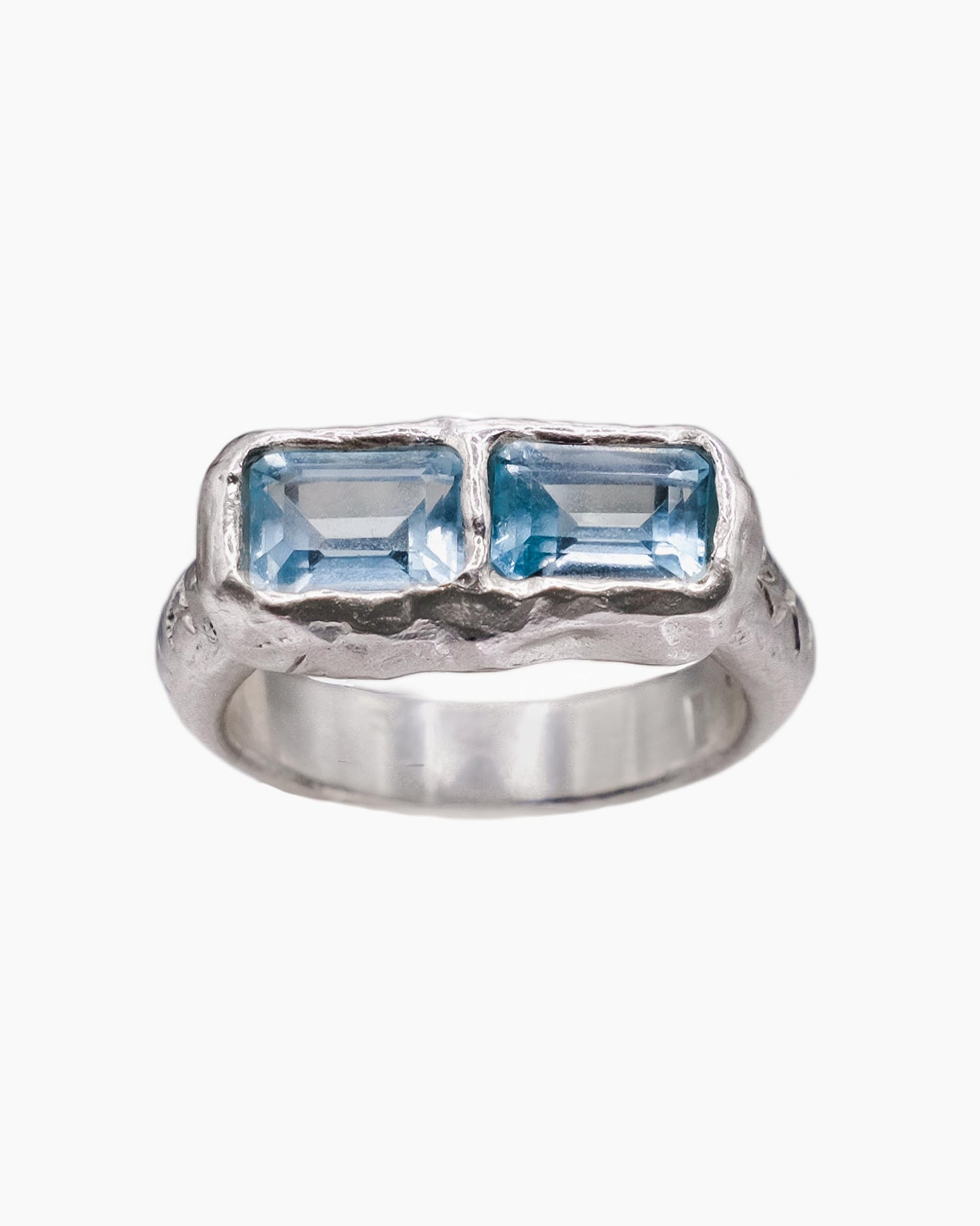 Silver ring with sky blue topaz stones.
